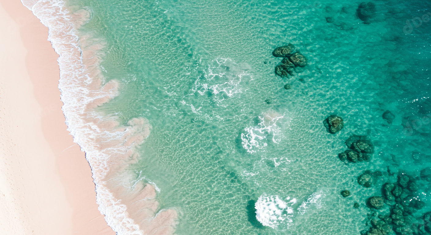 Aerial View Of Pristine Turquoise Ocean Waves And Sandy Beach