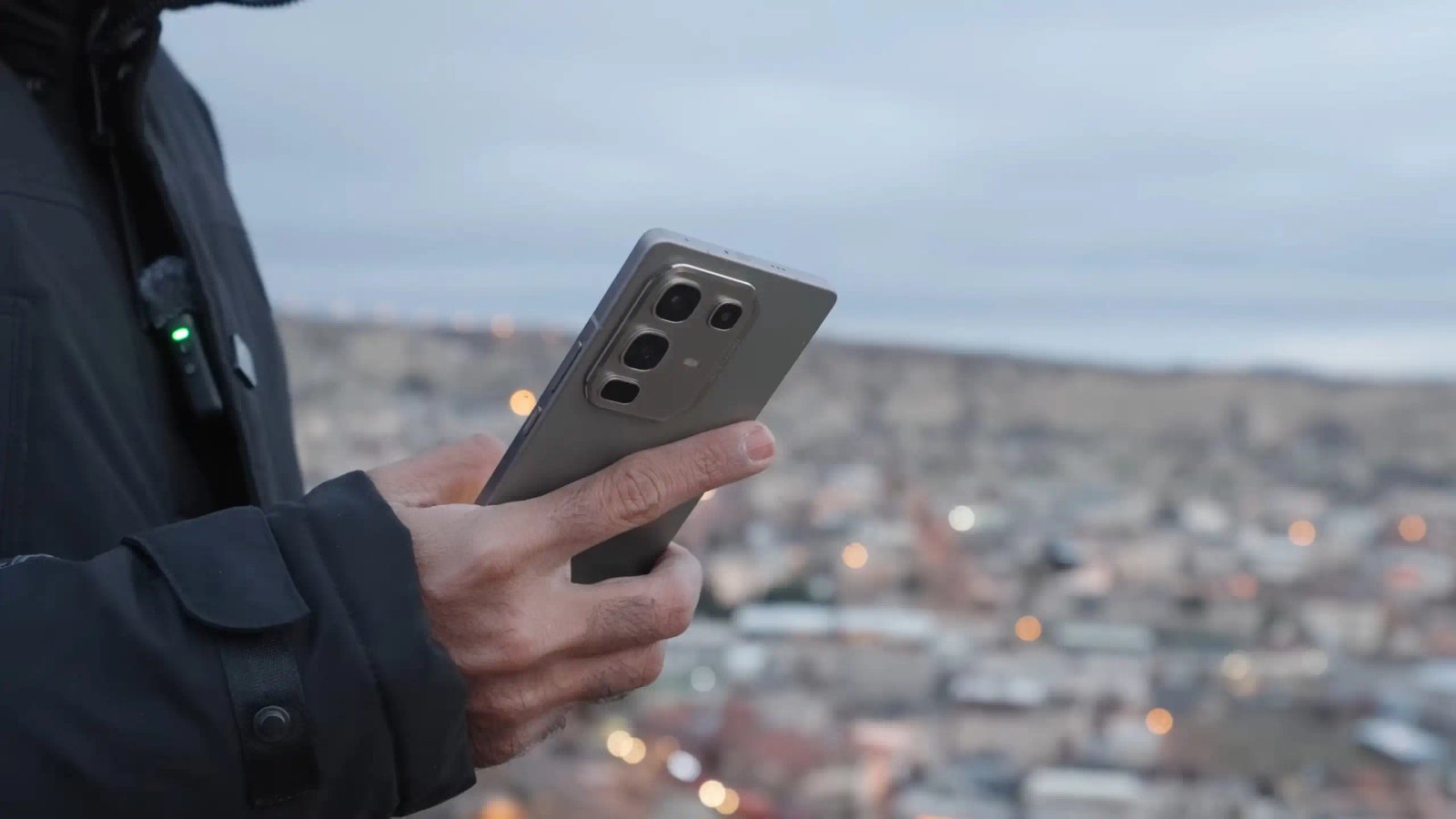 Man Holding A Modern Smartphone Over A City View