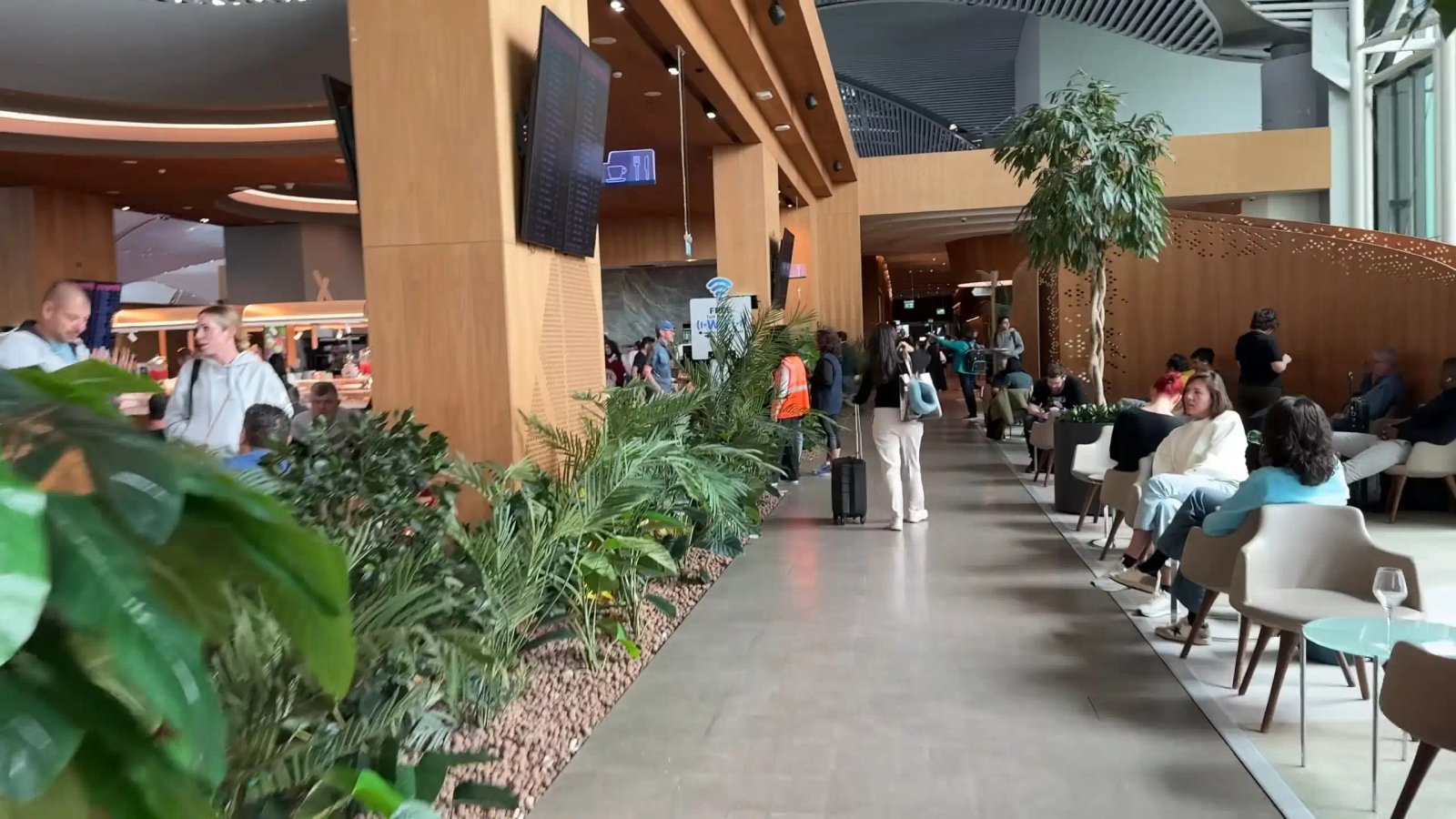 Passengers Waiting In A Modern And Spacious Airport Terminal
