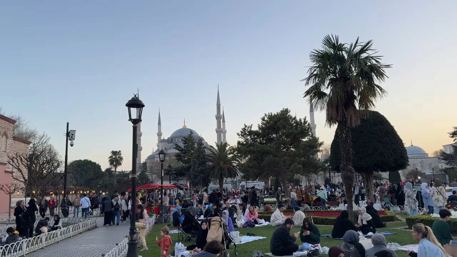 People Gathering In A Park Near The Blue Mosque At Sunset