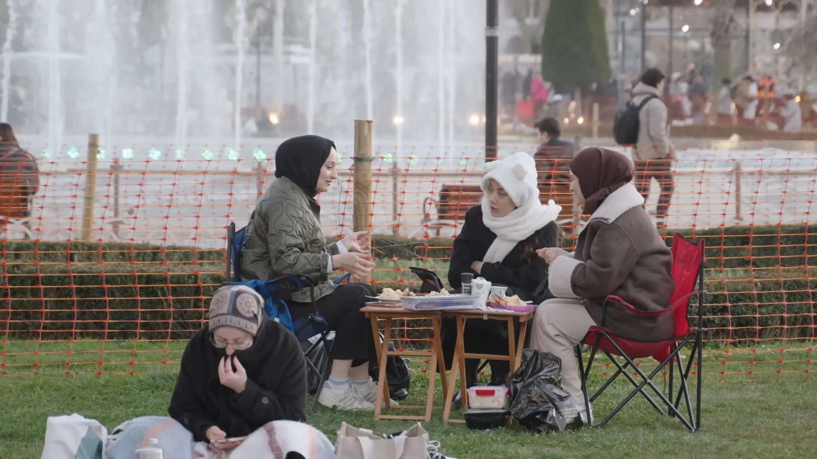 Women Socializing And Enjoying A Picnic In A Park