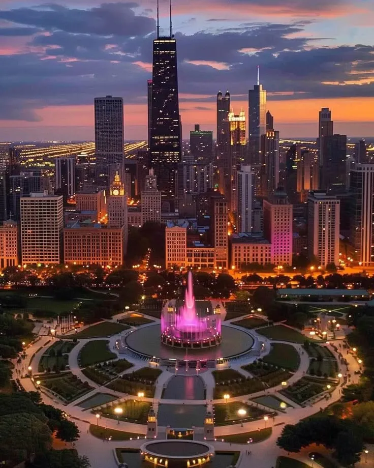 the city skyline is lit up at night