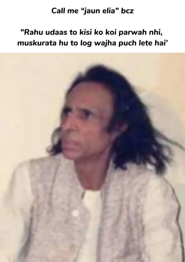 a woman with long hair sitting in front of a wall