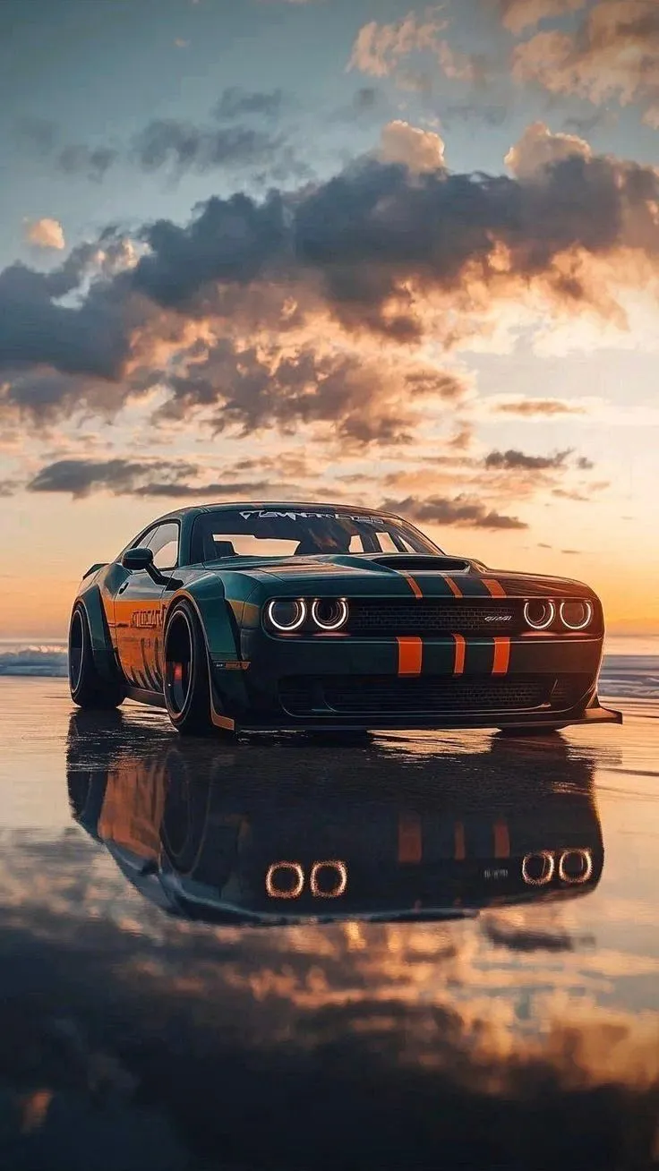 a sports car is parked on the beach in front of an orange and black stripe