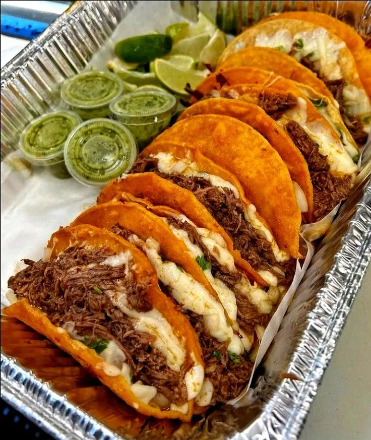several tacos are lined up on a tray