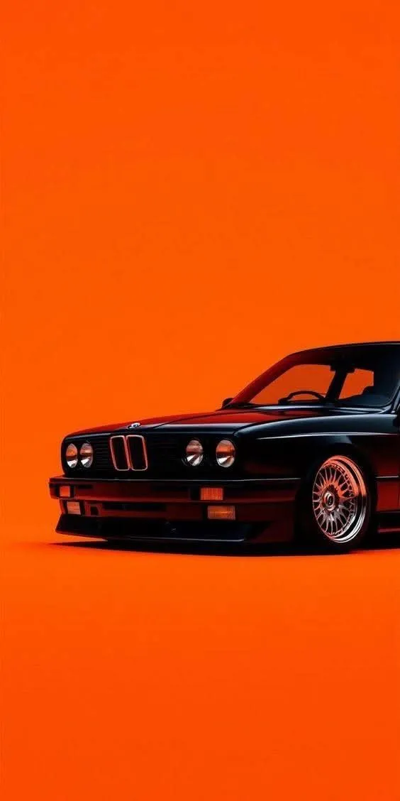 an orange and black car is shown in this artistic photo, with only the front wheels visible