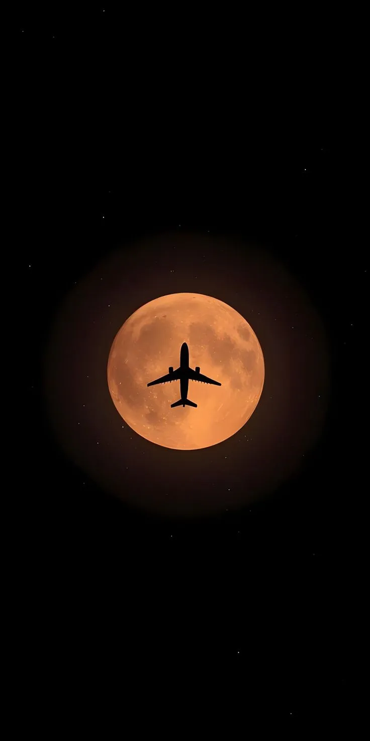 an airplane flying in front of a full moon