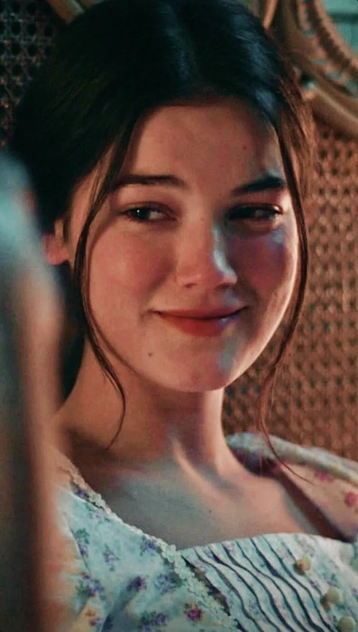 a young woman is smiling and looking at the camera