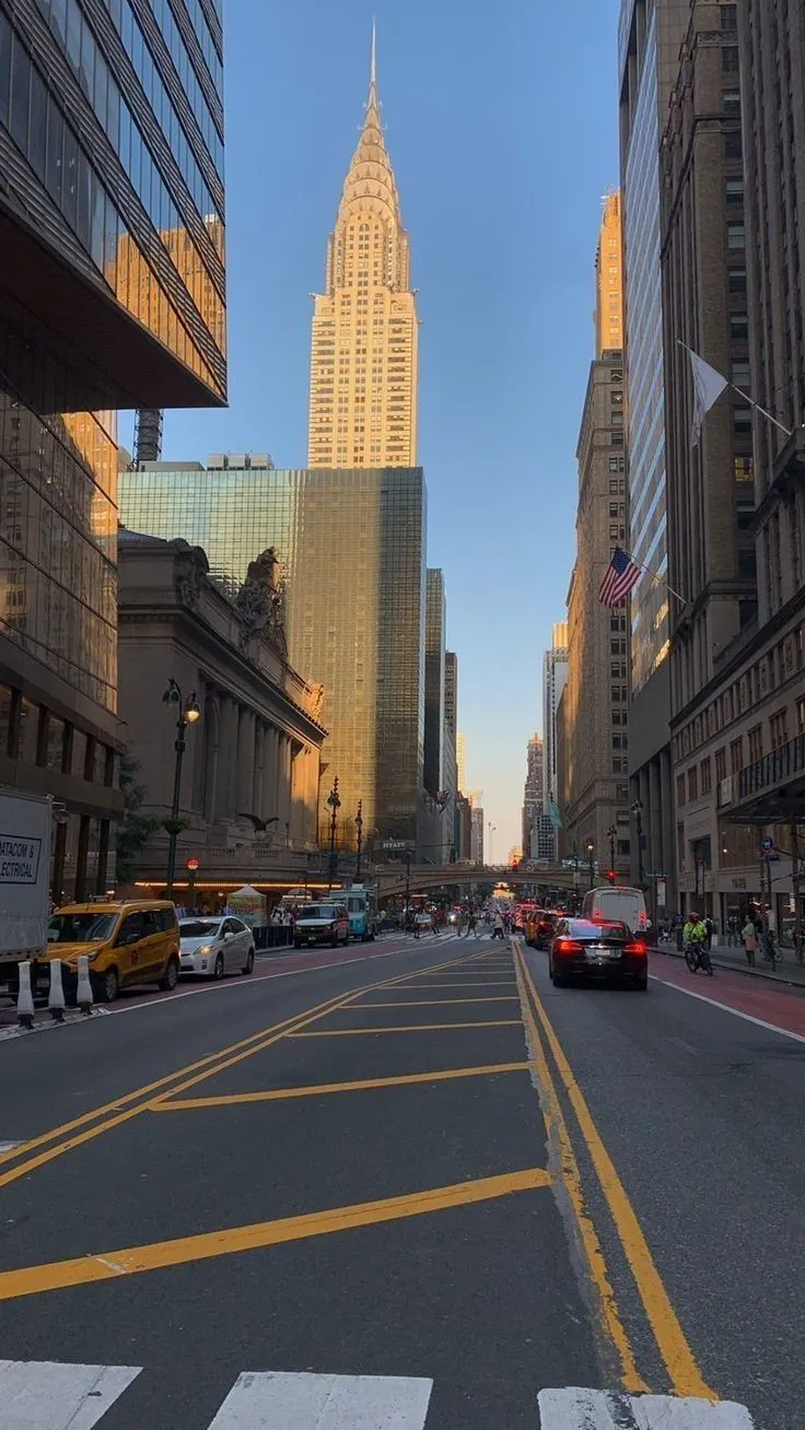 a city street with tall buildings in the background