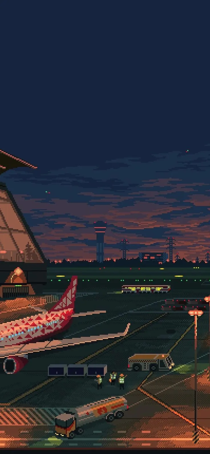 an airport at night with planes on the tarmac