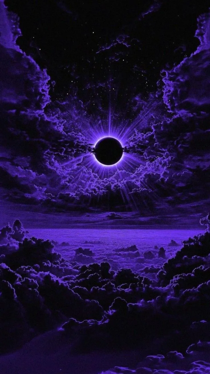 an eclipse in the night sky with clouds