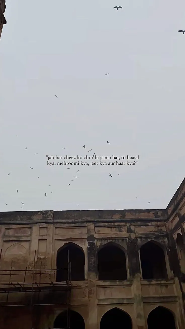 birds flying in the sky over an old building
