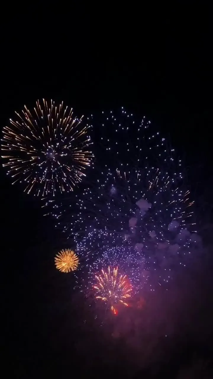 fireworks are lit up in the night sky with bright lights on them and dark background
