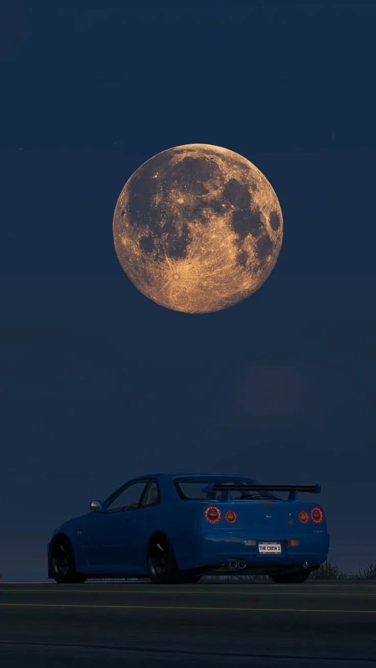 a blue car parked in front of a full moon