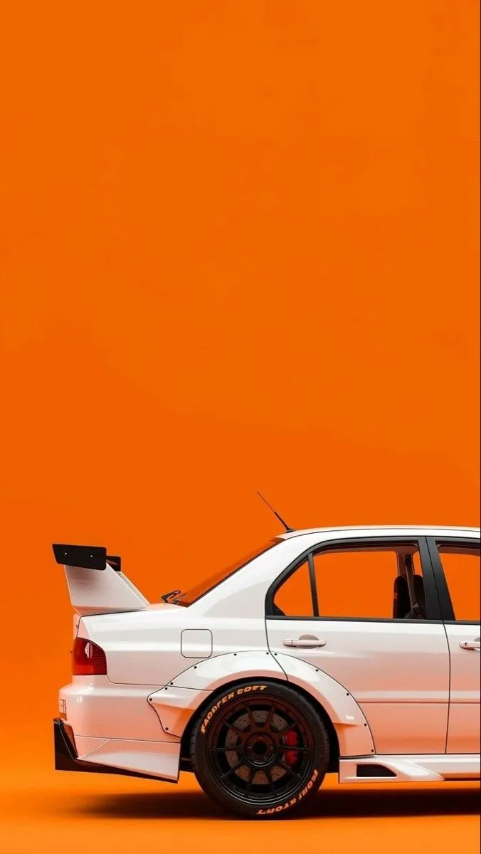 a white car parked in front of an orange wall