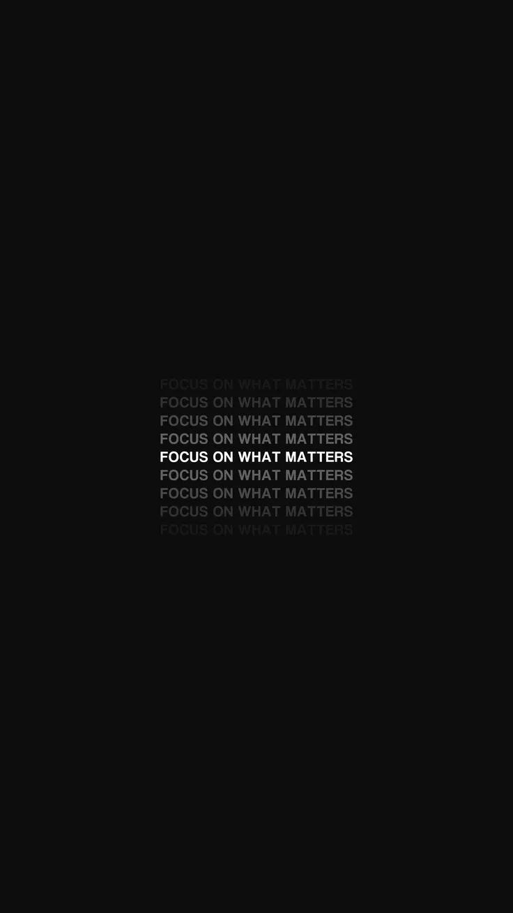 the words focus on what matters are written in white and black letters against a dark background