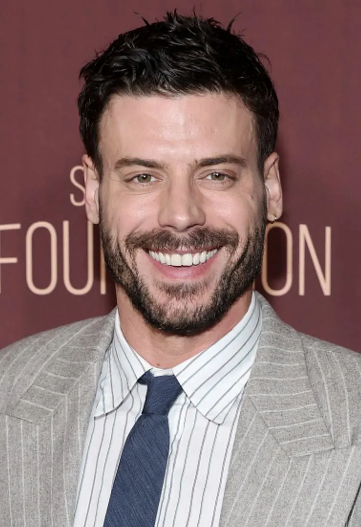 a smiling man in a suit and tie