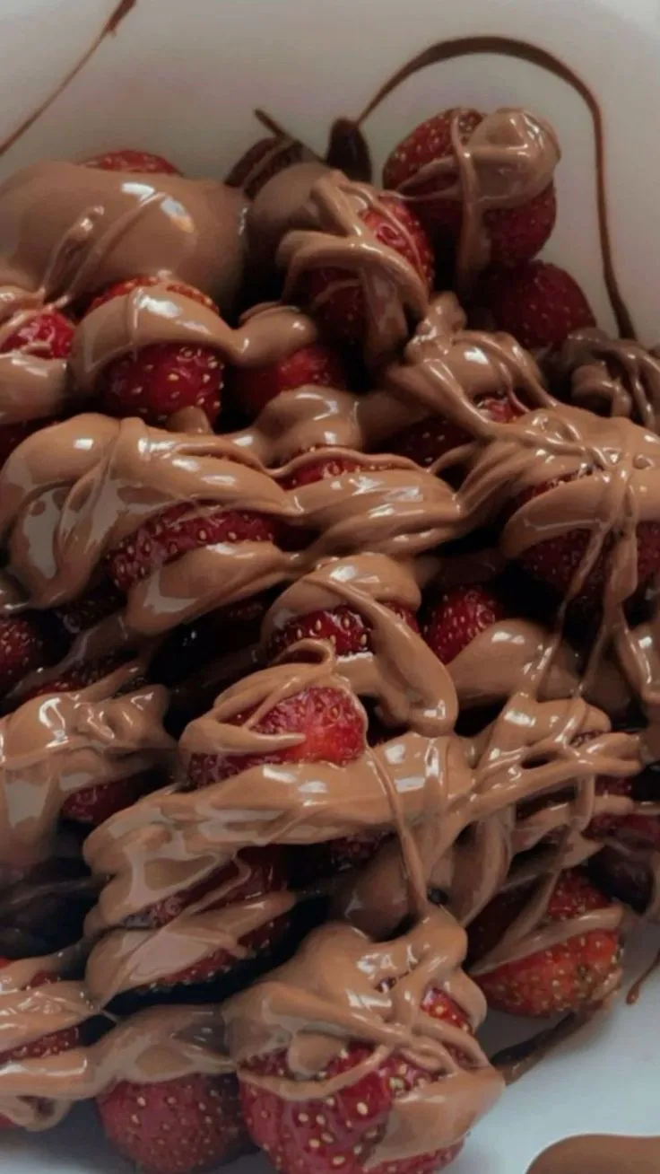 a white bowl filled with chocolate covered strawberries