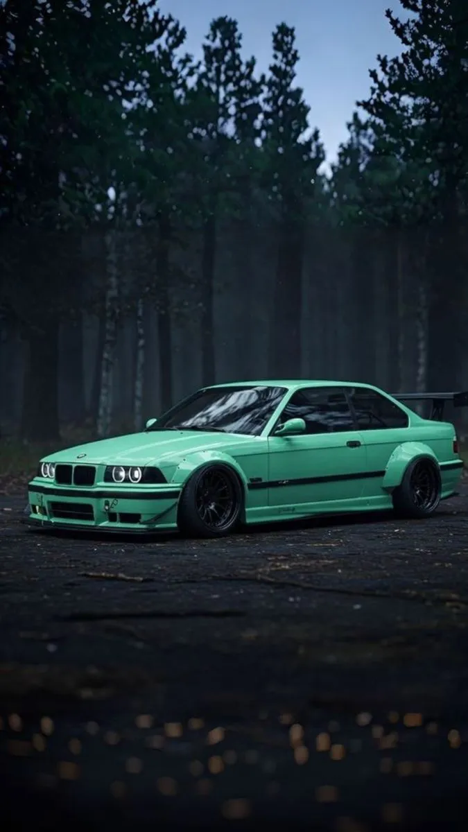 a green car parked in front of some trees