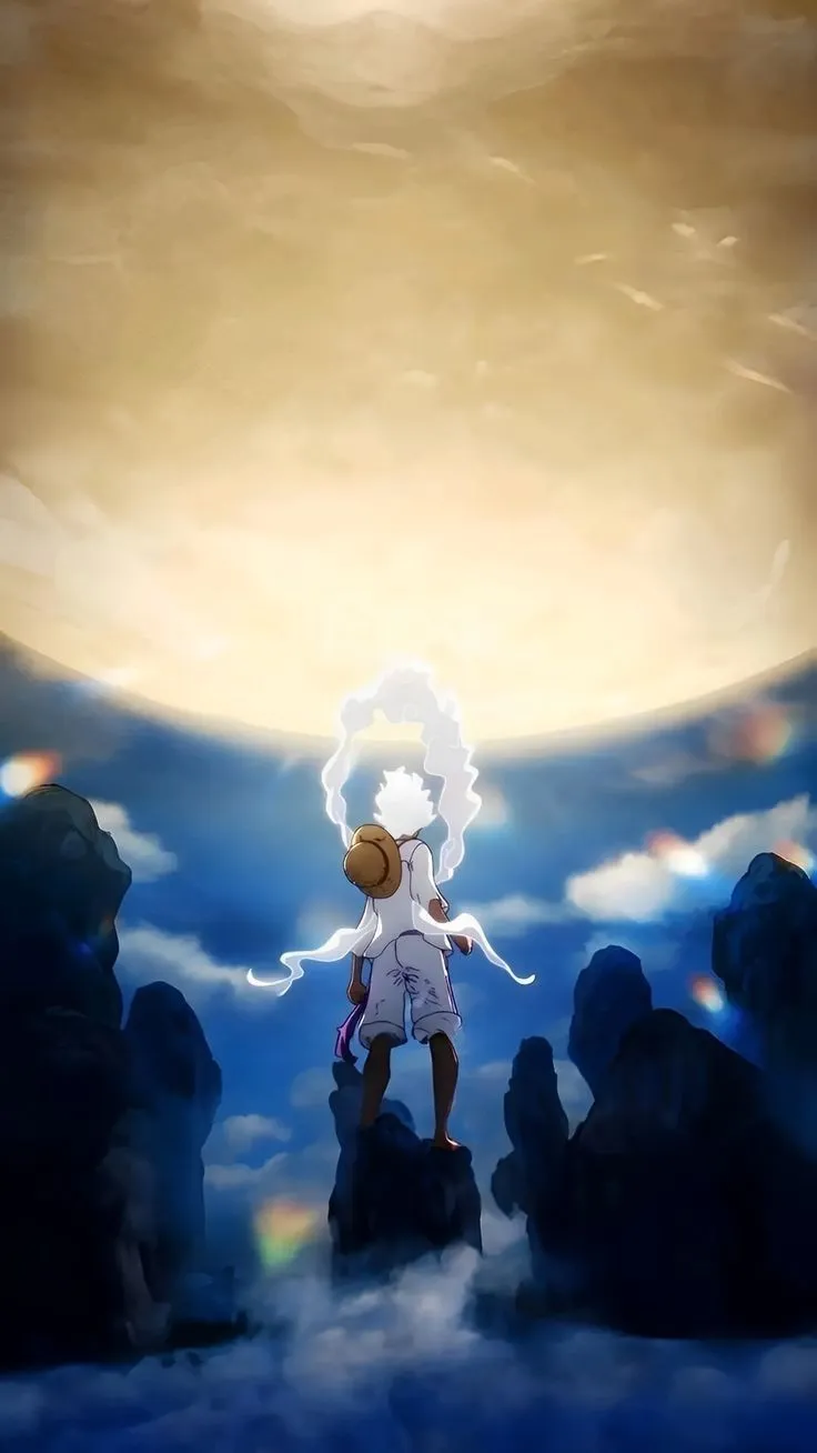 a person standing on top of a hill with clouds in the sky and an orange sun behind them