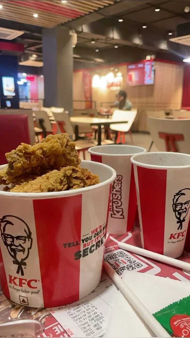 two cups filled with fried food sitting on top of a table next to each other