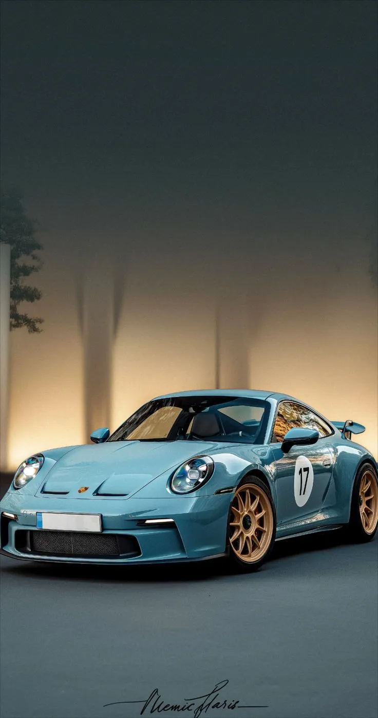 a blue sports car parked in front of a building with lights on it's side