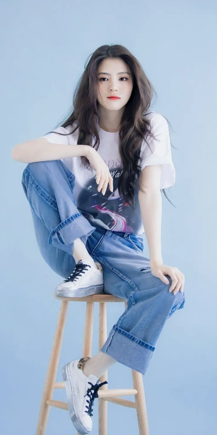 a woman sitting on top of a wooden stool
