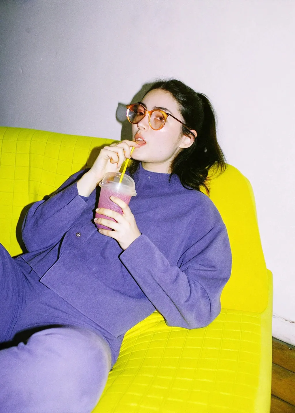 woman in glasses drinks smoothie