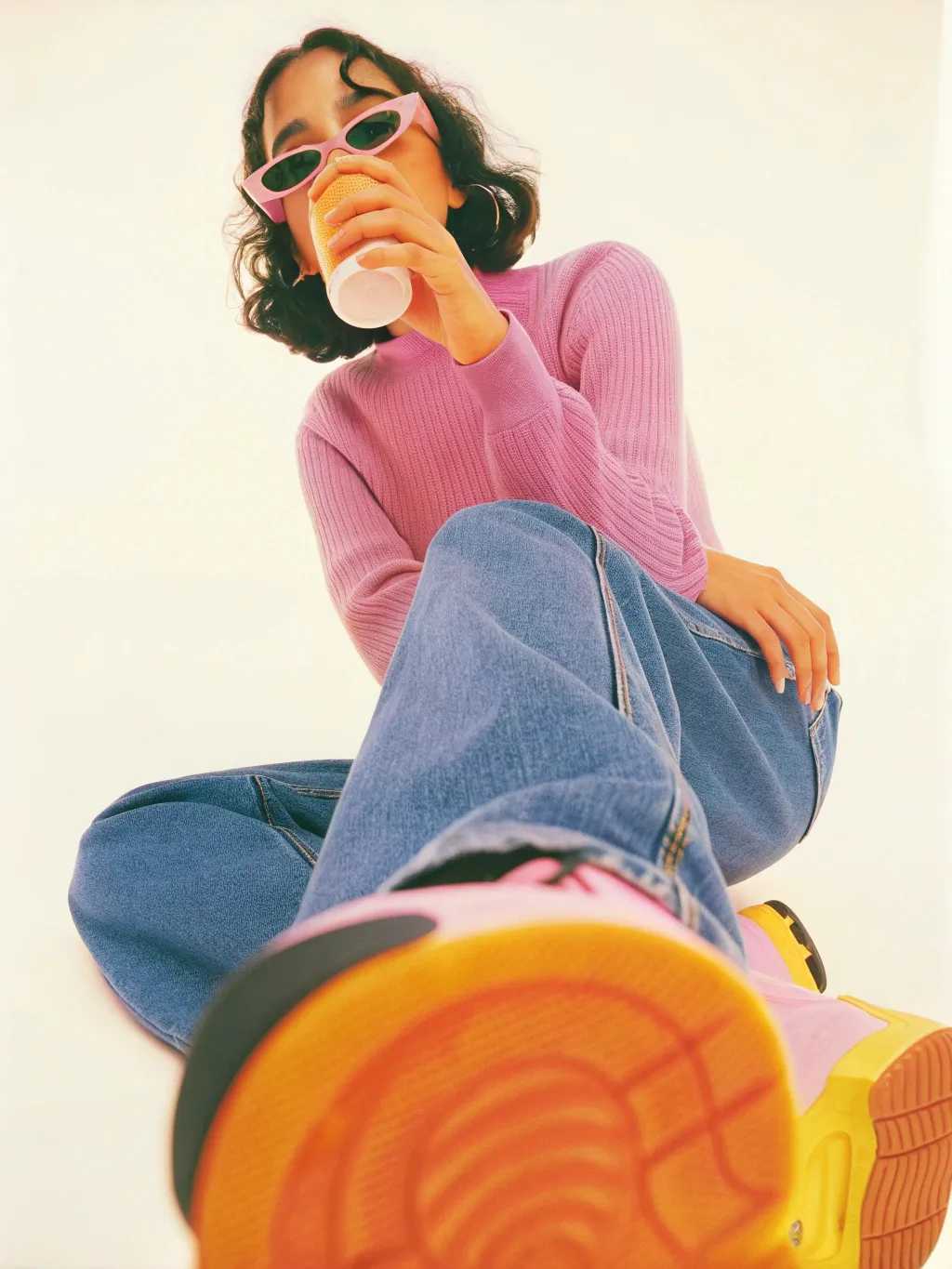 gen-z female drinking coffee, she's wearing oversized sunglasses. isolated. Wide...