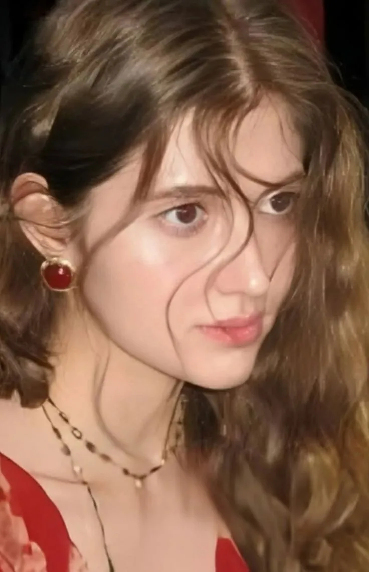 a woman in a red dress is looking at the camera with an odd look on her face