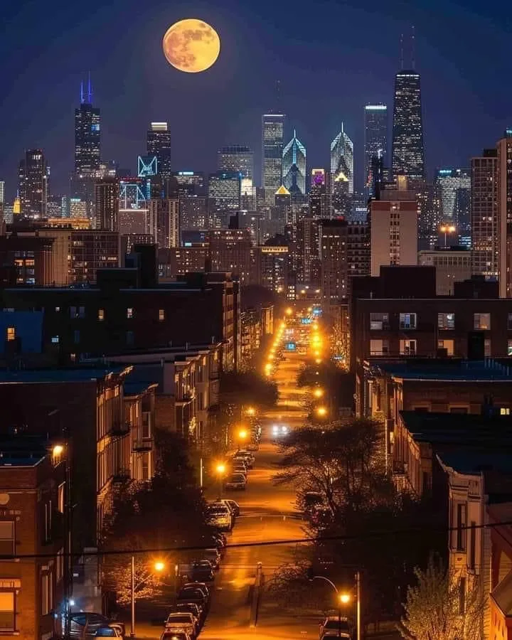 a full moon rises over the city skyline