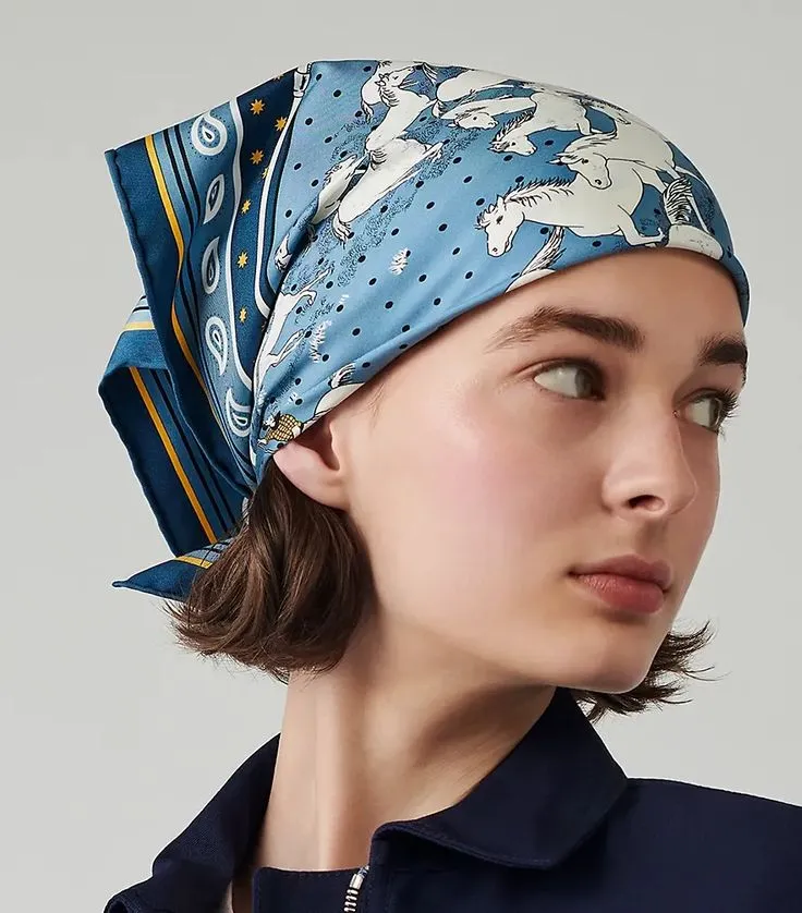 a woman wearing a blue bandana with an elephant print on the top and bottom